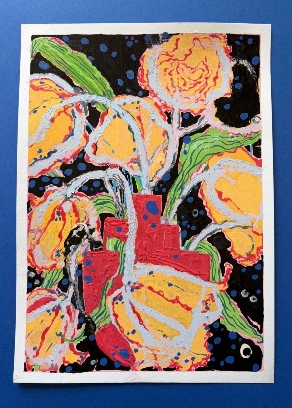 Golden flowers and green leaves against black with red geometric forms